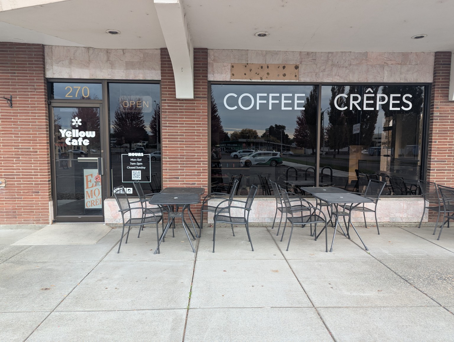 Yellow Cafe white coffee and crêpes window lettering and branded entrance